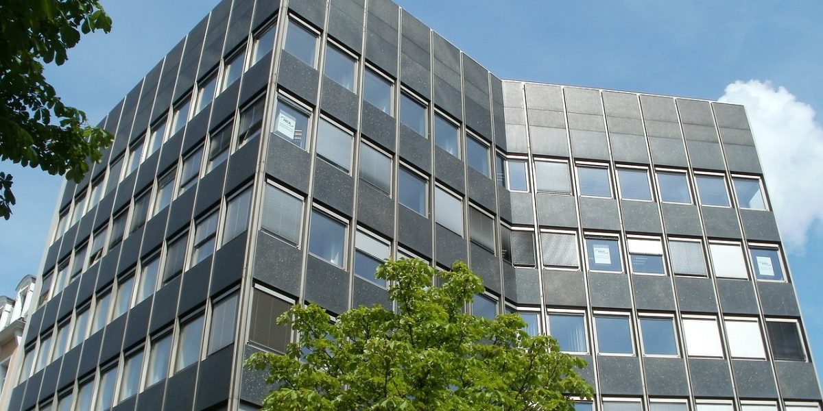 Commercial office building with a tree in front - Real estate dispute lawyers - Finkel Law Group