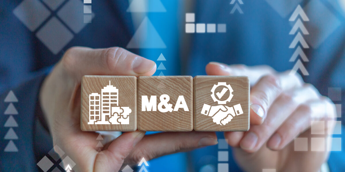 Merger and Acquisition Business - partnership concept on wooden dices in businessmans hands